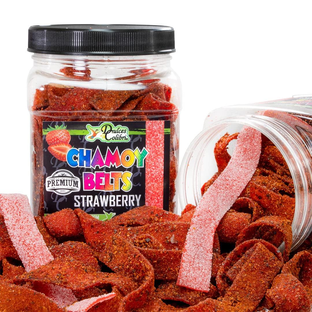 A clear plastic jar filled with red chamoy belts strawberry flavored gummy candies, with the label 'Dulces Colibri Premium Strawberry Chamoy Belts' on the lid.